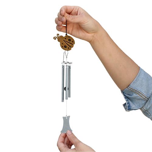 Jacob's Musical Chimes hand tuned wind chime ladybug held in hand for size.