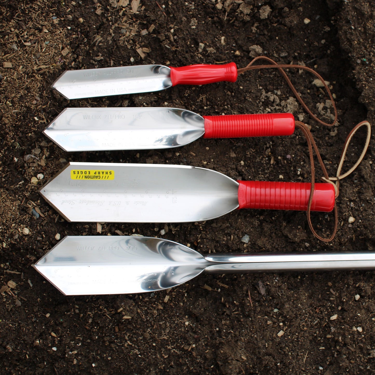 Wilcox stainless steel trowels next to each other for comparison, 9 inch, 12 inch, 14 inch, and 22 inch