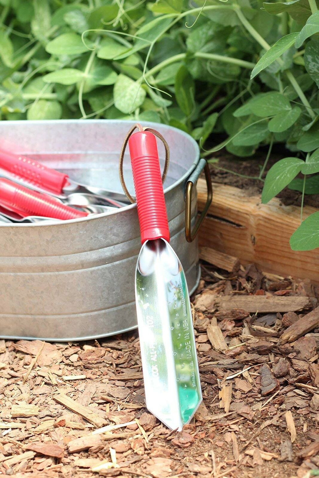 Wilcox 12 inch stainless steel trowel with red handle and leather wrist strap