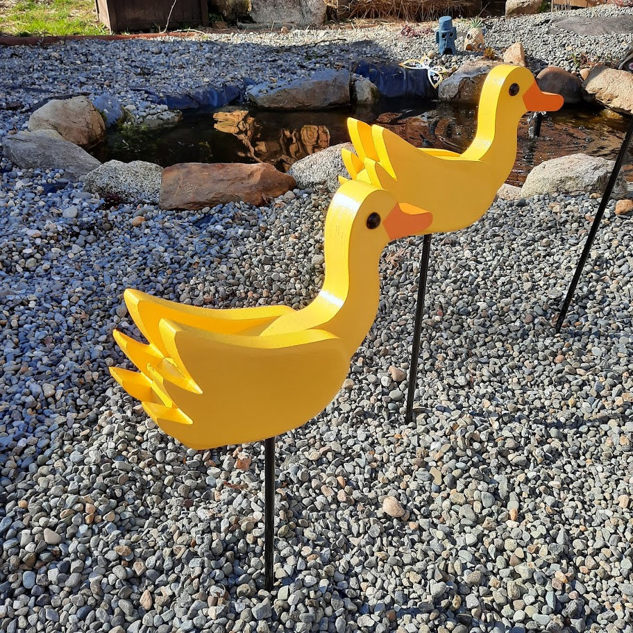 Two yellow baby ducks by the pond. Handmade by the Amish out of wood.